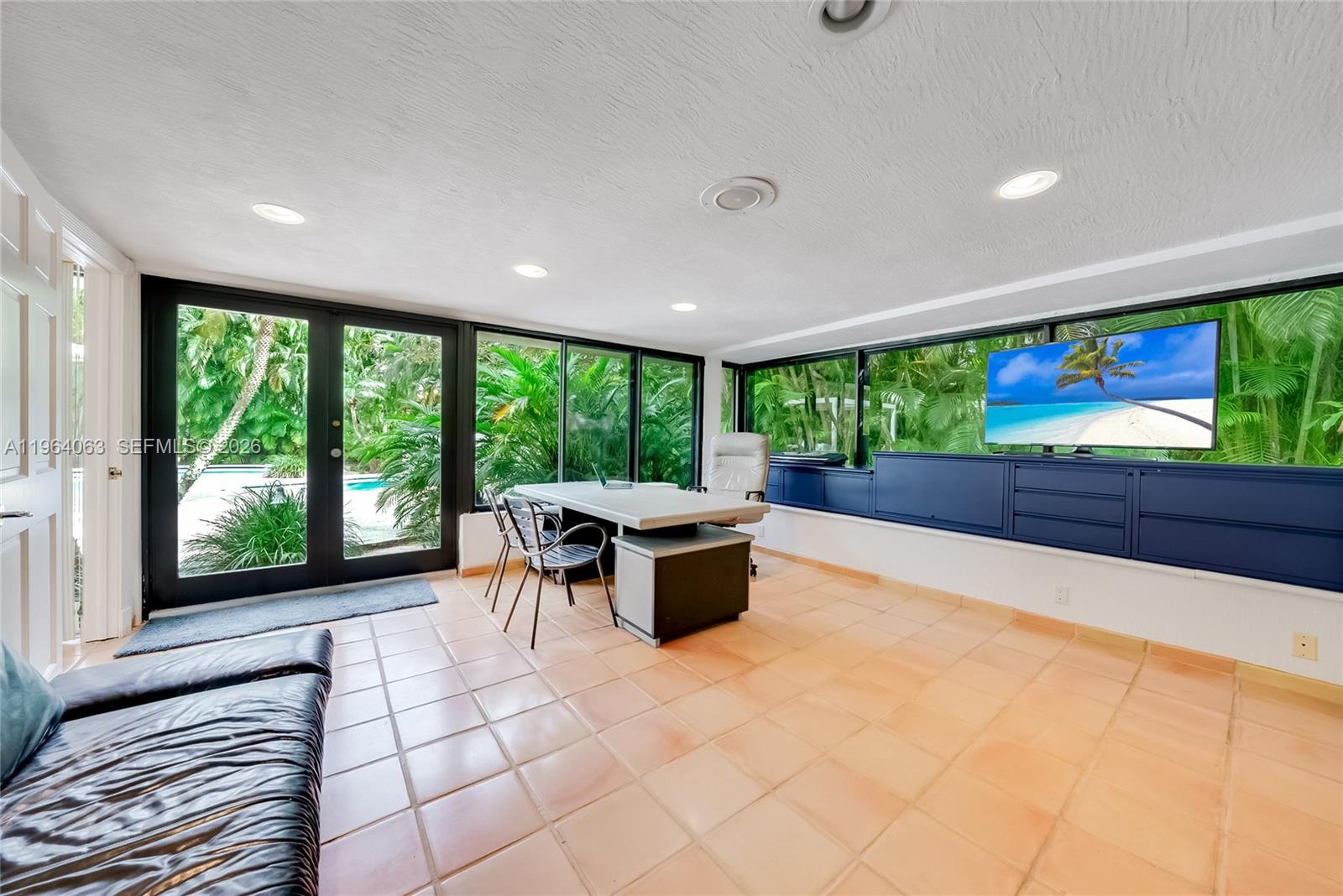 278 South Island Road Golden Beach, FL 33160 - Photo 34 of 57 a living room with furniture a floor to ceiling window and floor to ceiling window