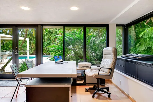 a bedroom with a white bed and a couch