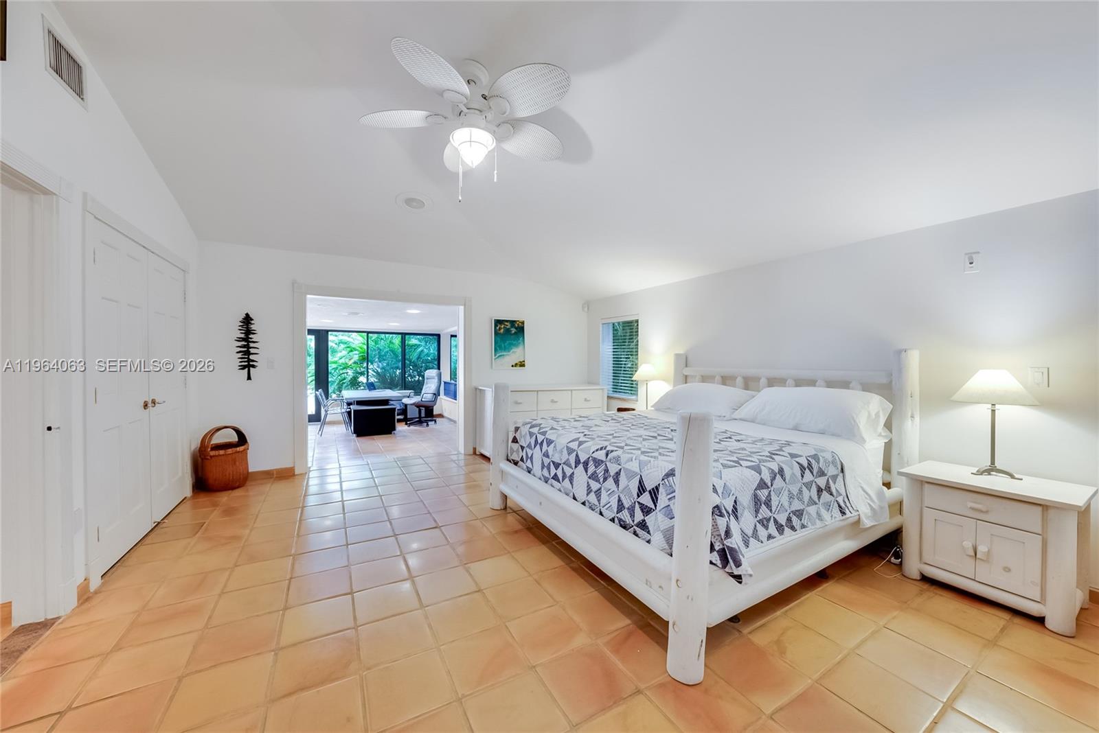 278 South Island Road Golden Beach, FL 33160 - Photo 36 of 57 a bed room with a bed and a chandelier