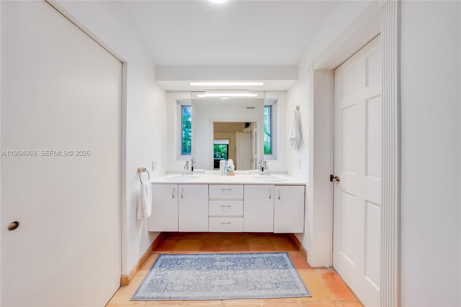 278 South Island Road Golden Beach, FL 33160 - Photo 39 of 57 a bathroom with a sink and a mirror
