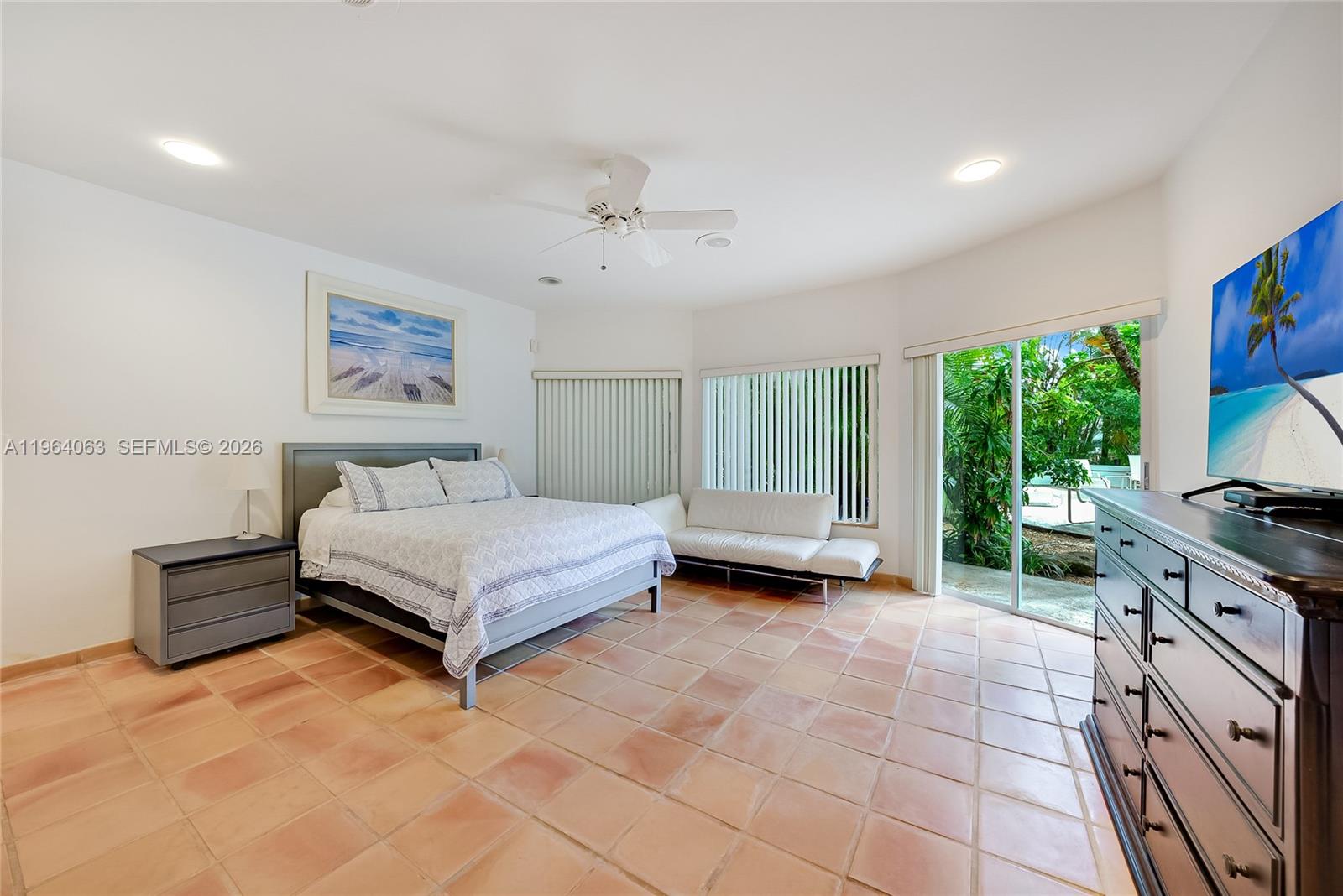 278 South Island Road Golden Beach, FL 33160 - Photo 44 of 57 a spacious bedroom with a bed and a flat screen tv