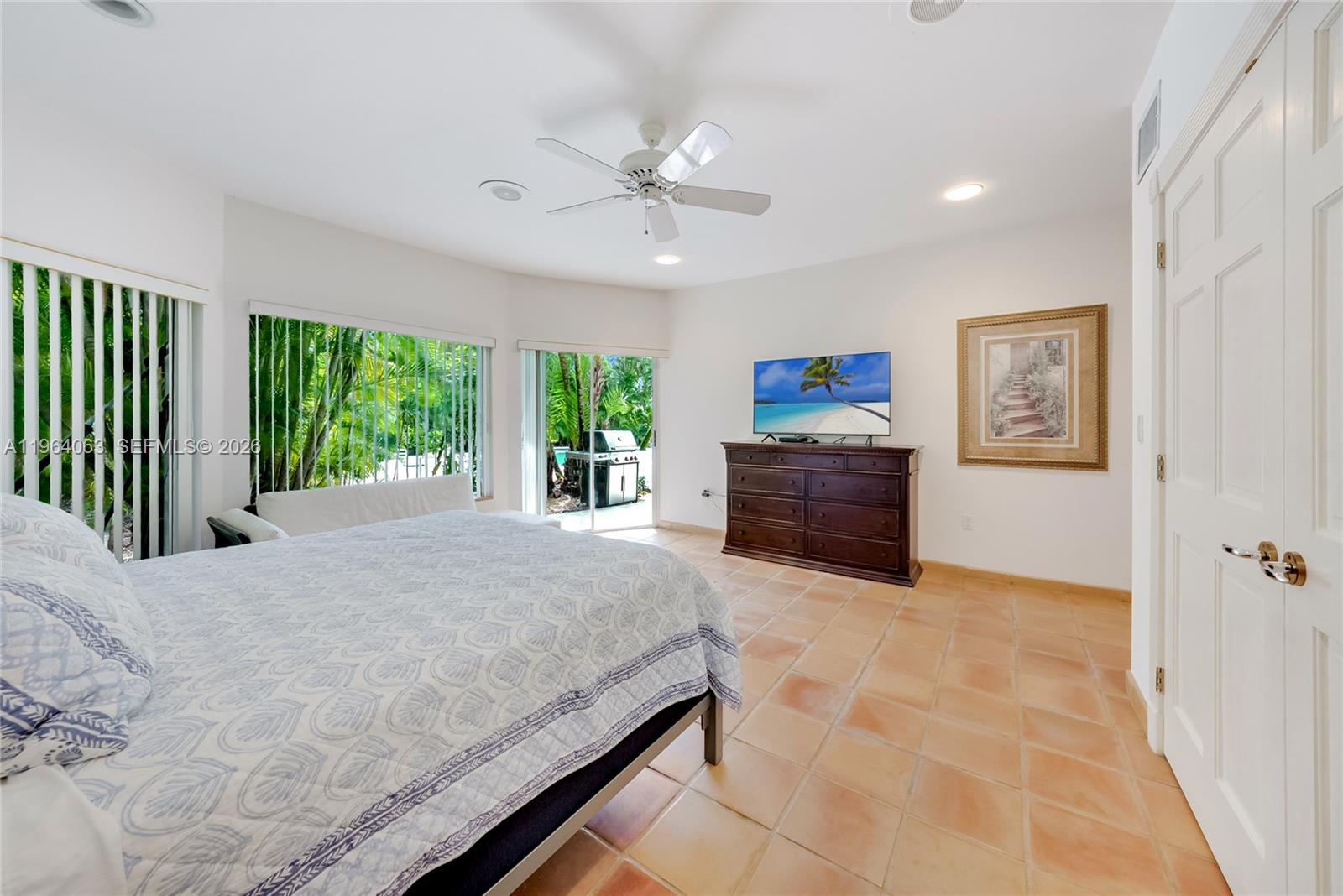 278 South Island Road Golden Beach, FL 33160 - Photo 45 of 57 a spacious bedroom with a large bed and a chandelier