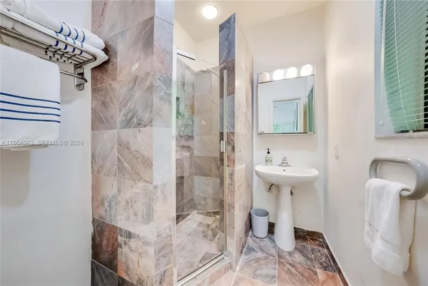 a kitchen with granite countertop a sink cabinets stainless steel appliances and a window