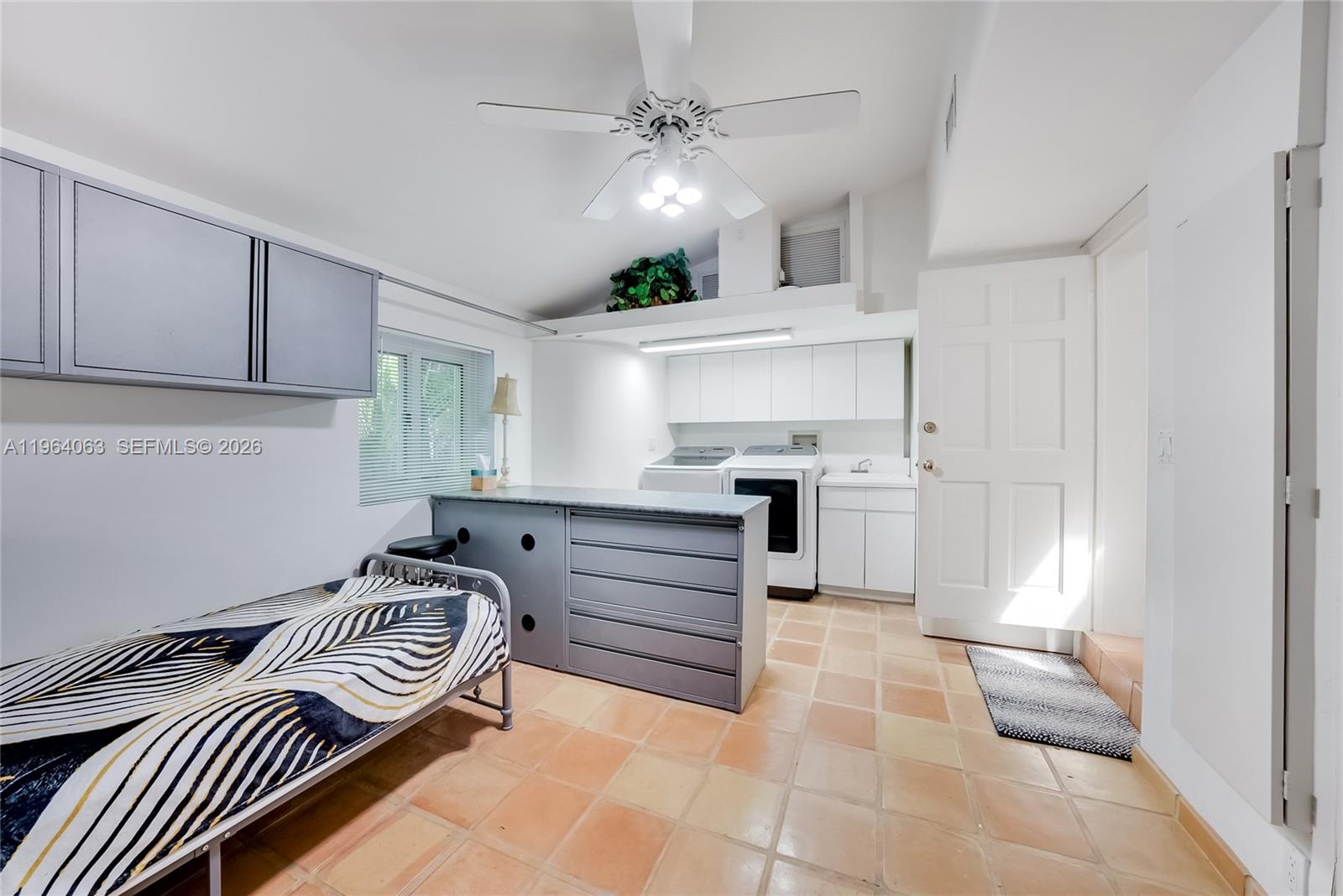 278 South Island Road Golden Beach, FL 33160 - Photo 48 of 57 a kitchen with granite countertop a sink cabinets stainless steel appliances and a window