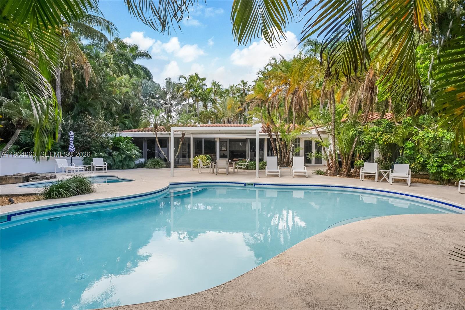 278 South Island Road Golden Beach, FL 33160 - Photo 6 of 57 a view of a swimming pool with chairs