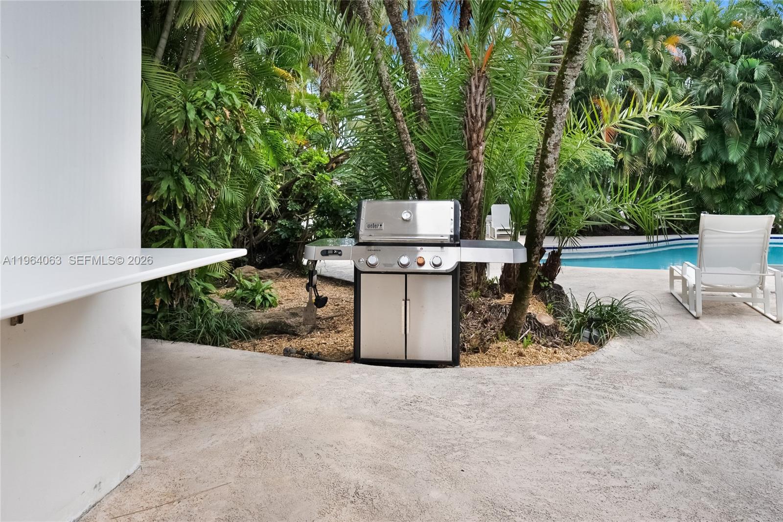 278 South Island Road Golden Beach, FL 33160 - Photo 10 of 57 a backyard of a house with large trees and plants