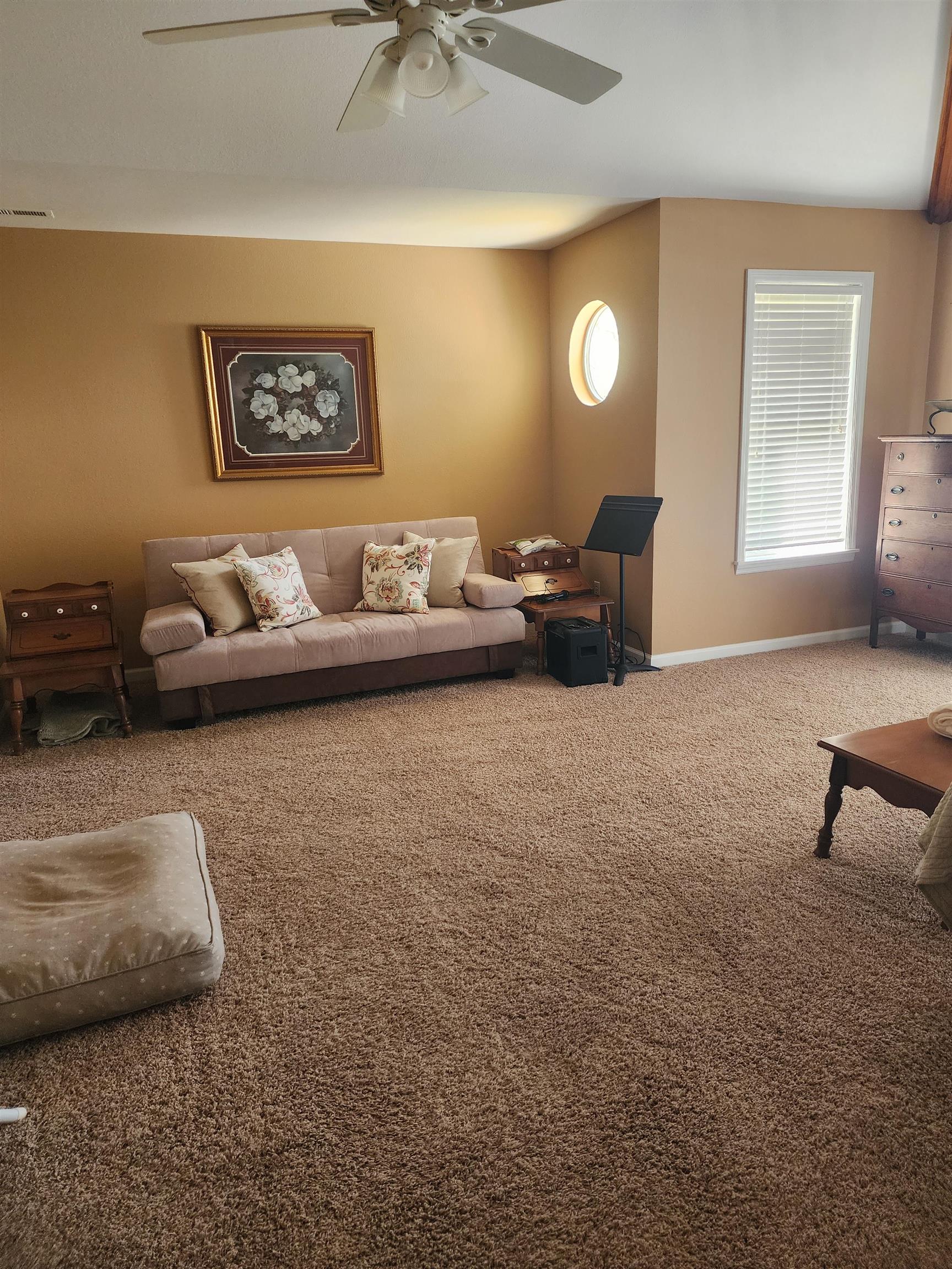 71 Chickasaw Trace Cherokee, AL 35616 - Photo 13 of 19 Spacious room featuring textured carpeting, a ceiling fan, a rectangular window with blinds, and a circular window