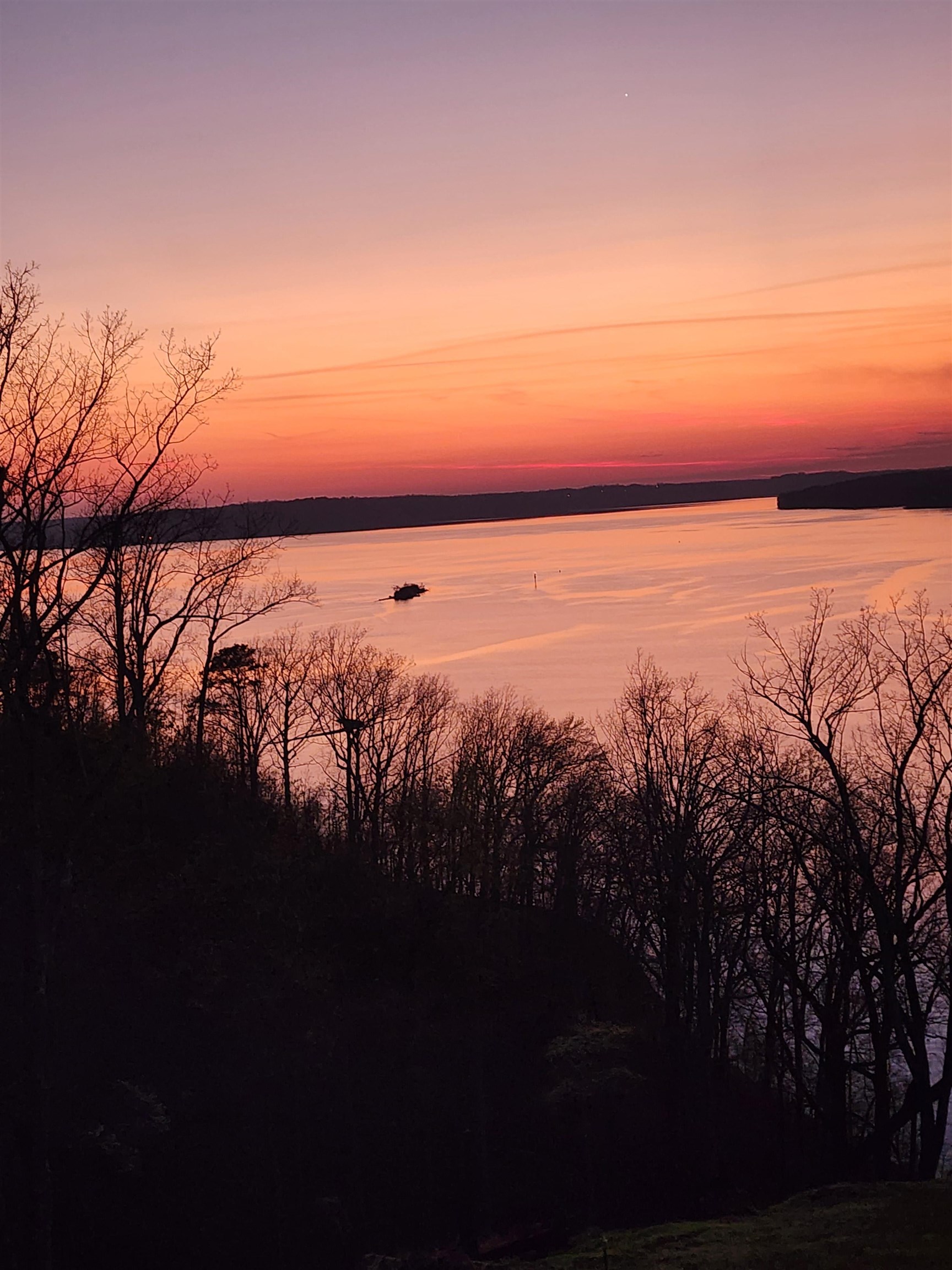 71 Chickasaw Trace Cherokee, AL 35616 - Photo 19 of 19 Expansive water body with a vibrant sunset and distant tree-lined shores
