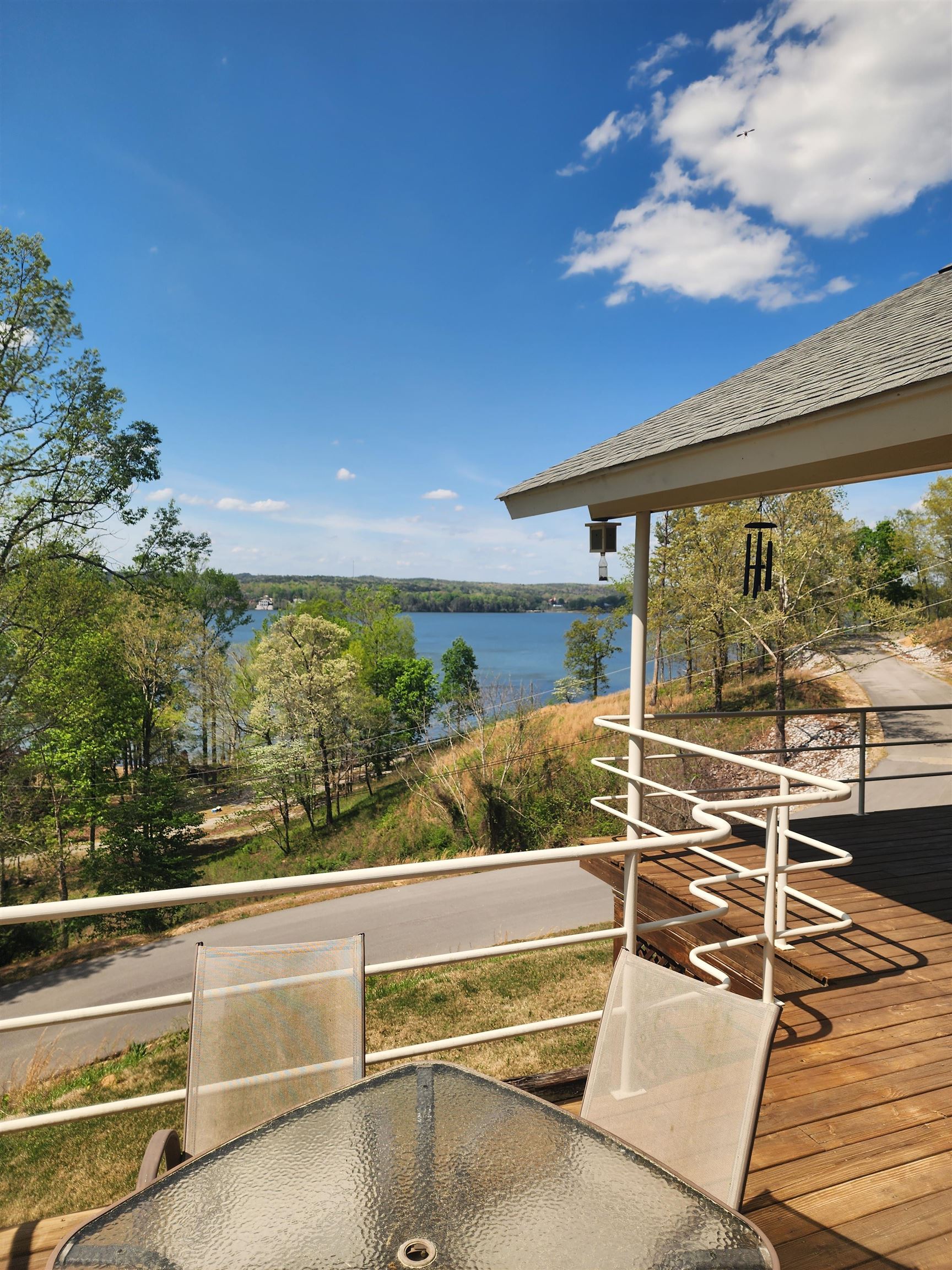 71 Chickasaw Trace Cherokee, AL 35616 - Photo 2 of 19 Expansive wood-finish deck with a white railing system, featuring a partial roof overhang