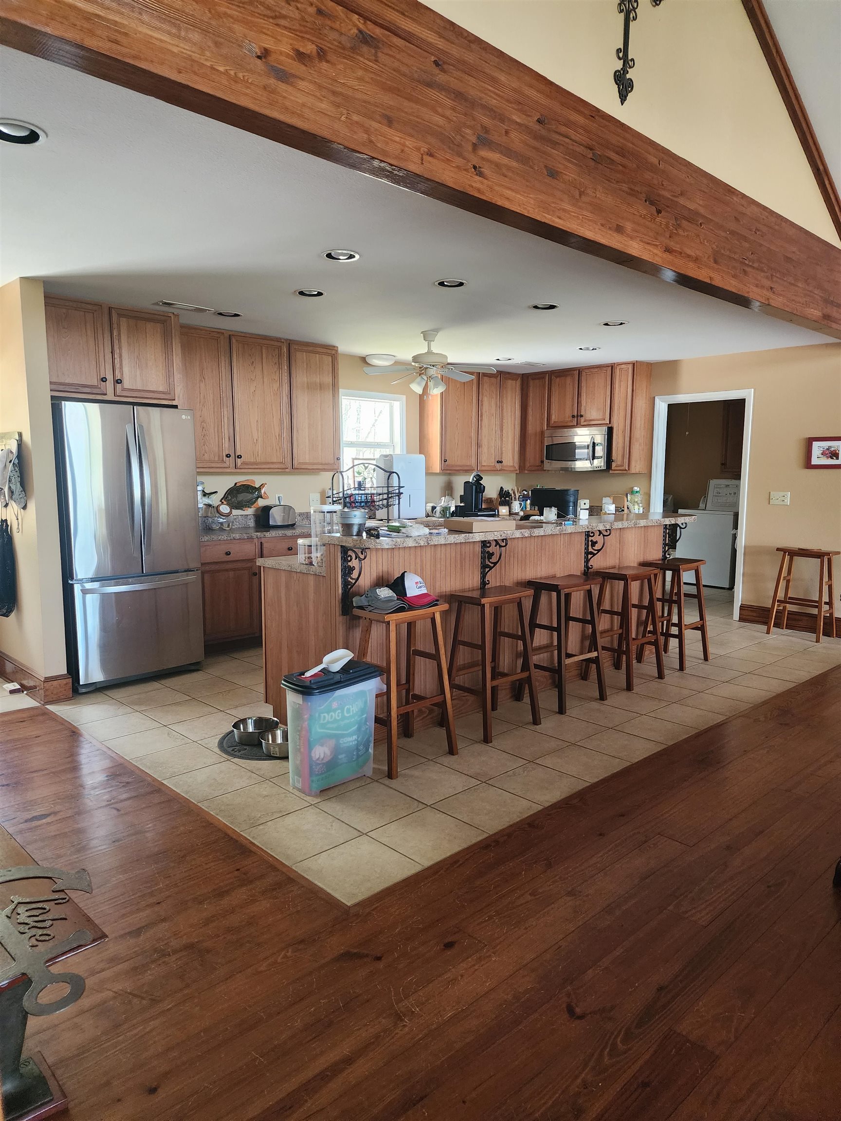 71 Chickasaw Trace Cherokee, AL 35616 - Photo 10 of 19 Expansive kitchen featuring wood-finish cabinetry, stainless steel appliances, and an oversized island with a breakfast bar