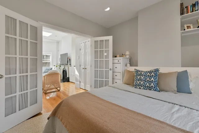 a bedroom with a bed and wooden floor