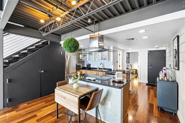 a kitchen with granite countertop lots of counter top space and stainless steel appliances