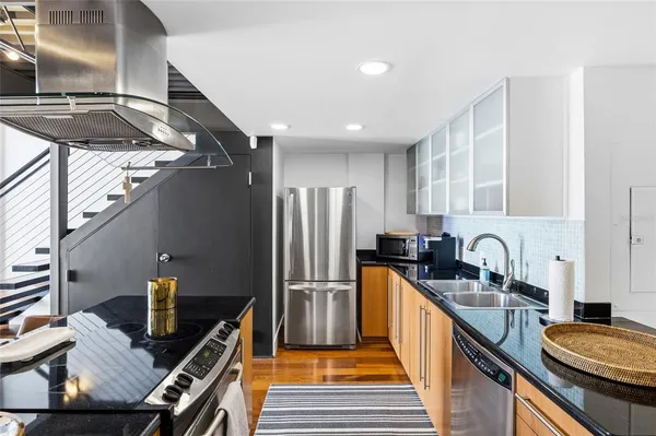 a kitchen with sink refrigerator and cabinets