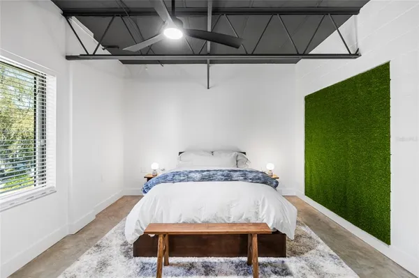 a bedroom with a bed with the view of bathroom