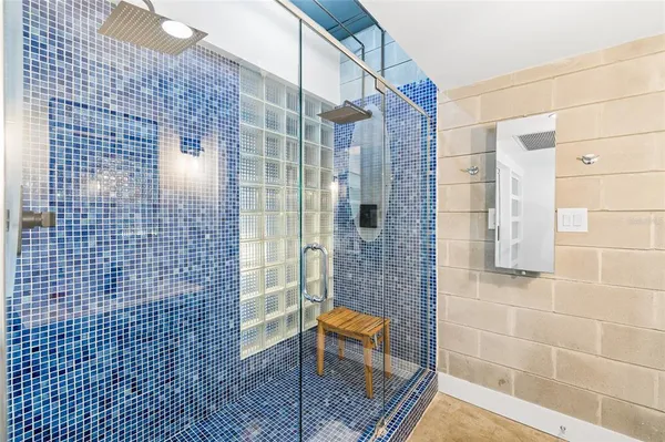 a bathroom with a sink shower and a mirror