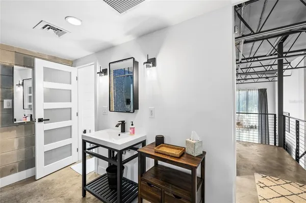 a view of a hallway with wooden floor and entryway