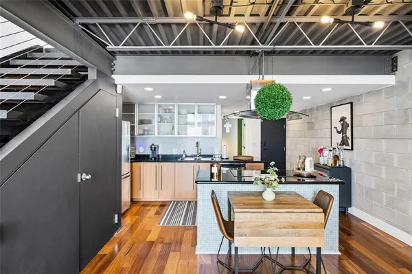 a living room with stainless steel appliances kitchen island granite countertop furniture and a kitchen view