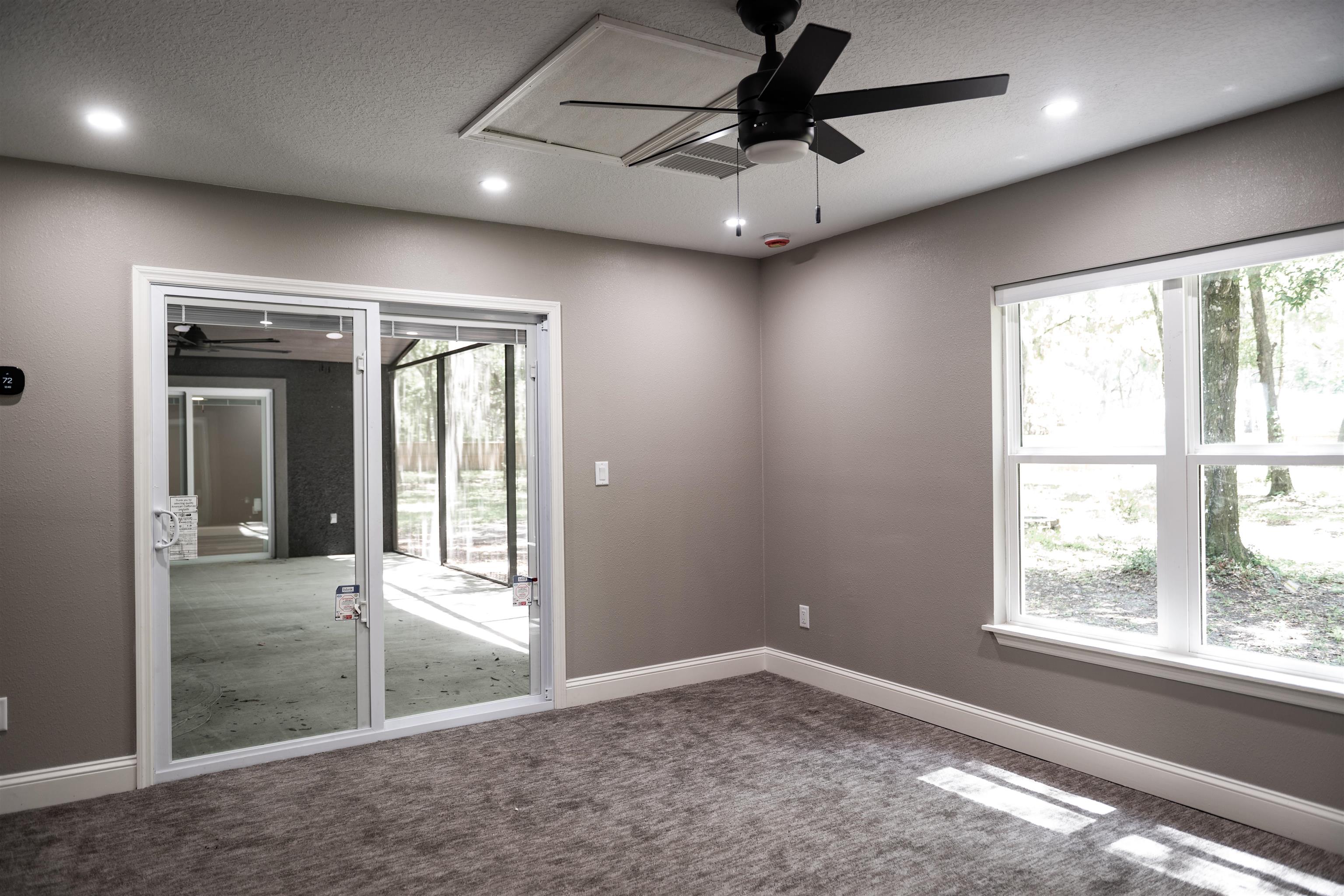 2950 Kings Road St. Augustine, FL 32086 - Photo 25 of 42 an empty room with windows and ceiling fan