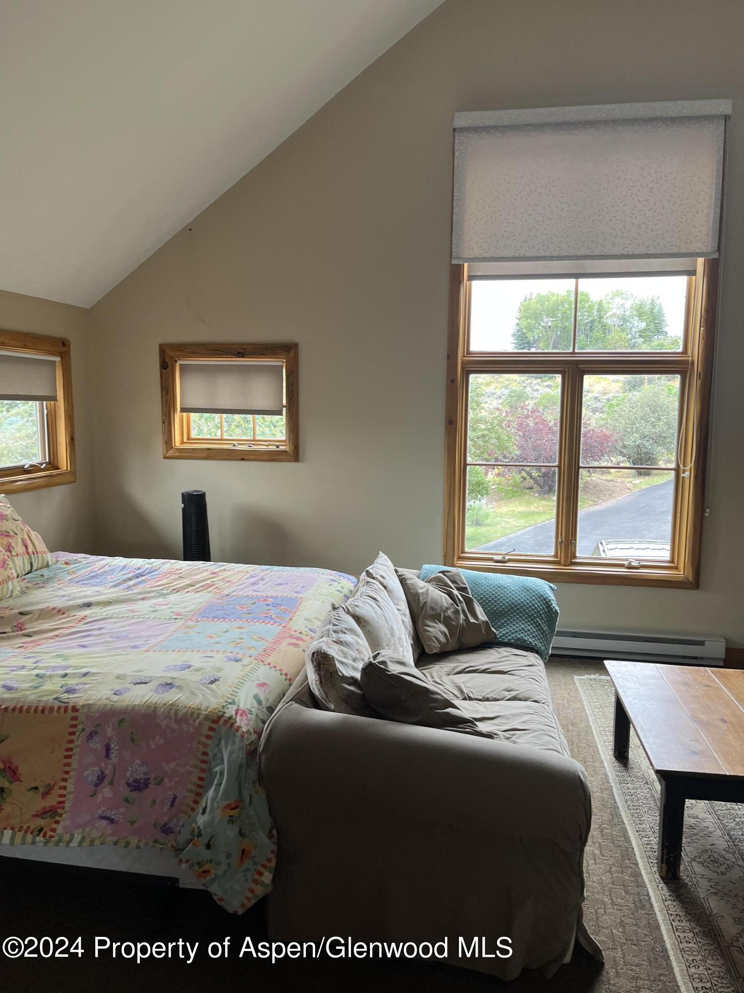 234 Light Hill Road Snowmass, CO 81654 - Photo 15 of 22 a bedroom with a bed and window