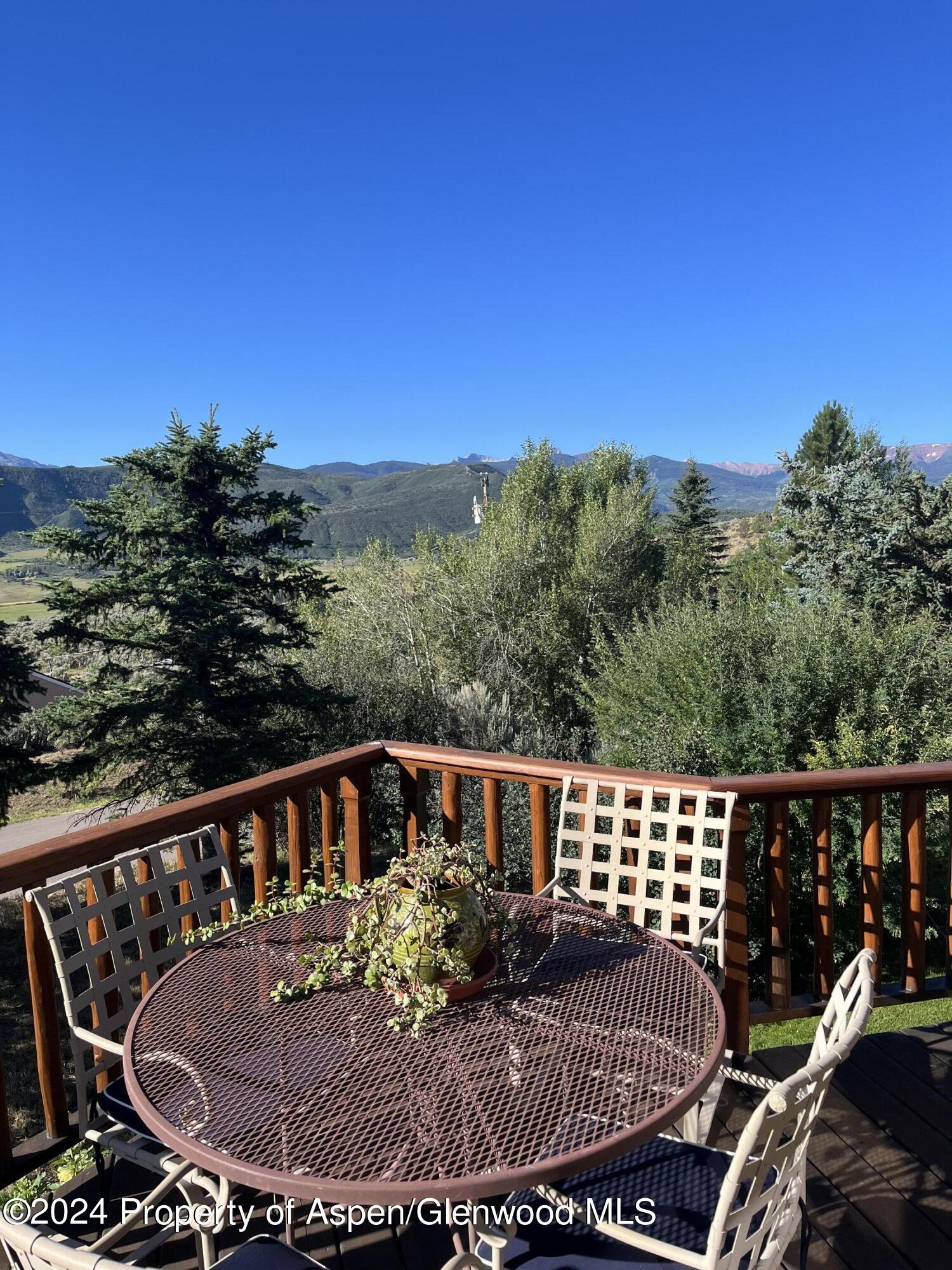 234 Light Hill Road Snowmass, CO 81654 - Photo 21 of 22 a balcony with wooden floor table and chairs