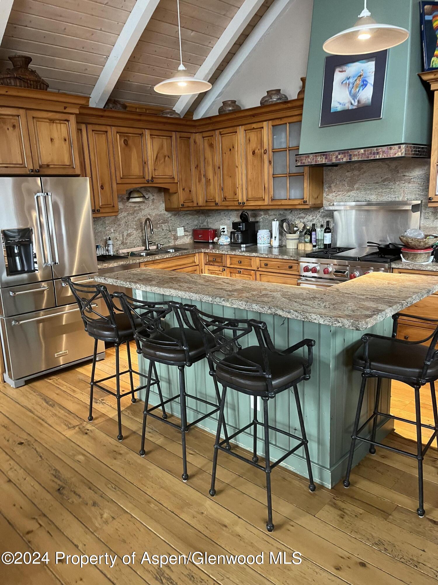 234 Light Hill Road Snowmass, CO 81654 - Photo 4 of 22 a kitchen with stainless steel appliances granite countertop a stove a sink and a refrigerator