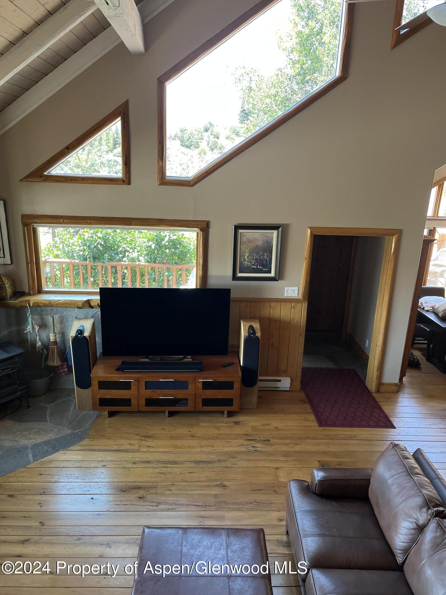 234 Light Hill Road Snowmass, CO 81654 - Photo 7 of 22 a living room with furniture a flat screen tv and a window