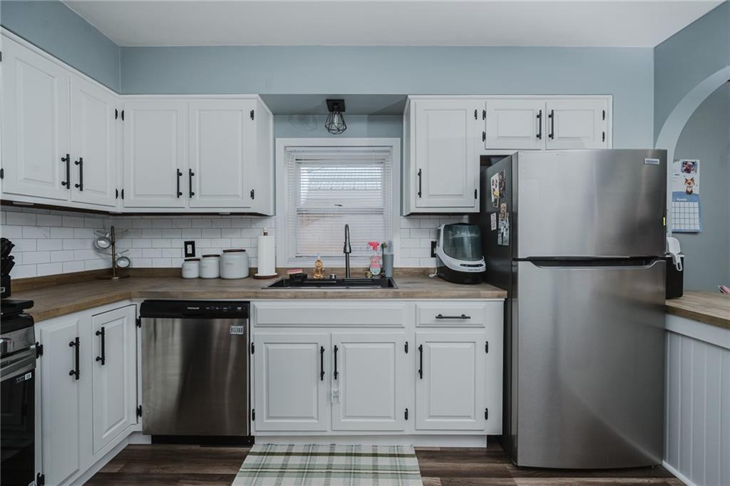 426 Grant Street Indiana, PA 15701 - Photo 7 of 33 a kitchen with stainless steel appliances granite countertop a refrigerator sink and white cabinets