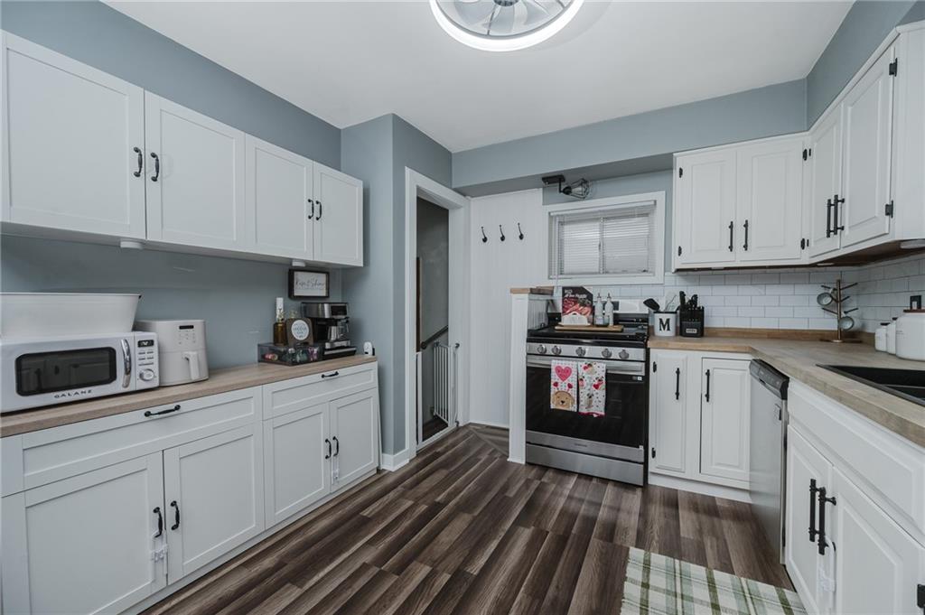 426 Grant Street Indiana, PA 15701 - Photo 8 of 33 a kitchen with a sink dishwasher stove and white cabinets