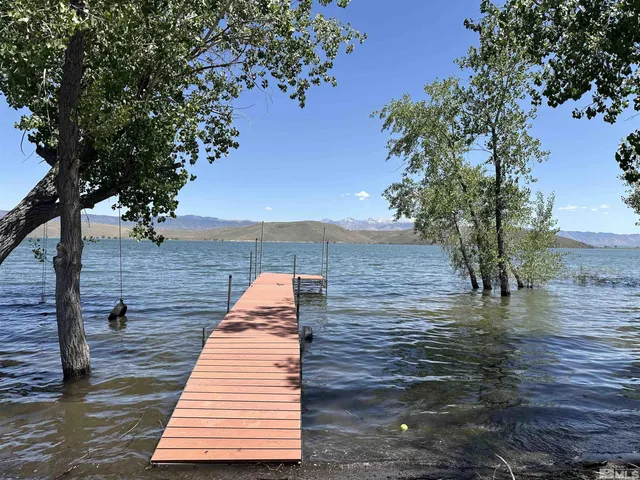 a view of a lake with large trees