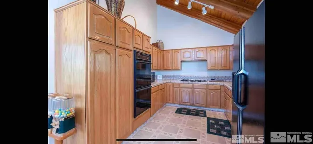 a kitchen with stainless steel appliances granite countertop a refrigerator and a stove