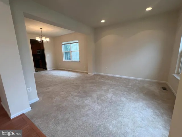 an empty room with a fireplace and a window