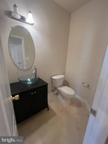 a bathroom with a toilet and a mirror