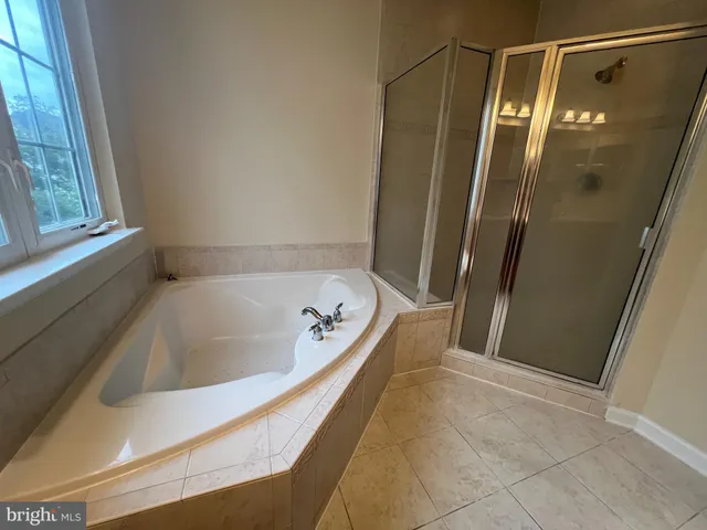 a bathroom with a tub and shower