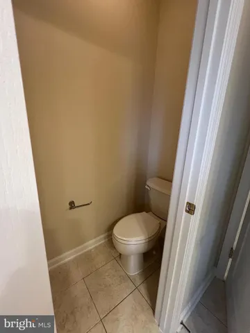 a white toilet sitting next to a sink