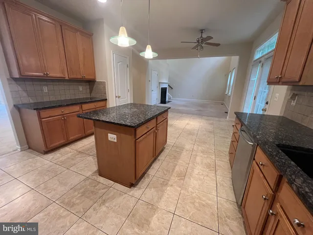 a kitchen with stainless steel appliances granite countertop a sink and a stove