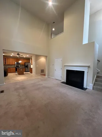 a view of empty room with a fireplace