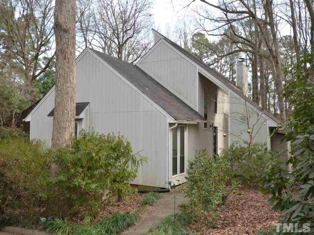2812 Old Orchard Road Raleigh, NC 27607 - Photo 1 of 25 a view of a white house next to a yard with large trees