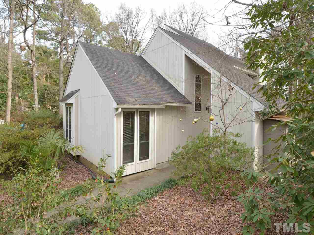 2812 Old Orchard Road Raleigh, NC 27607 - Photo 2 of 25 a view of a white house next to a yard with large trees