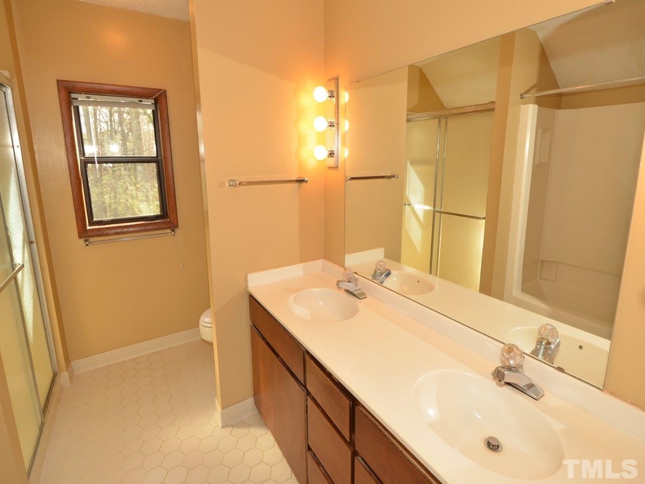 2812 Old Orchard Road Raleigh, NC 27607 - Photo 12 of 25 a bathroom with a sink and a mirror