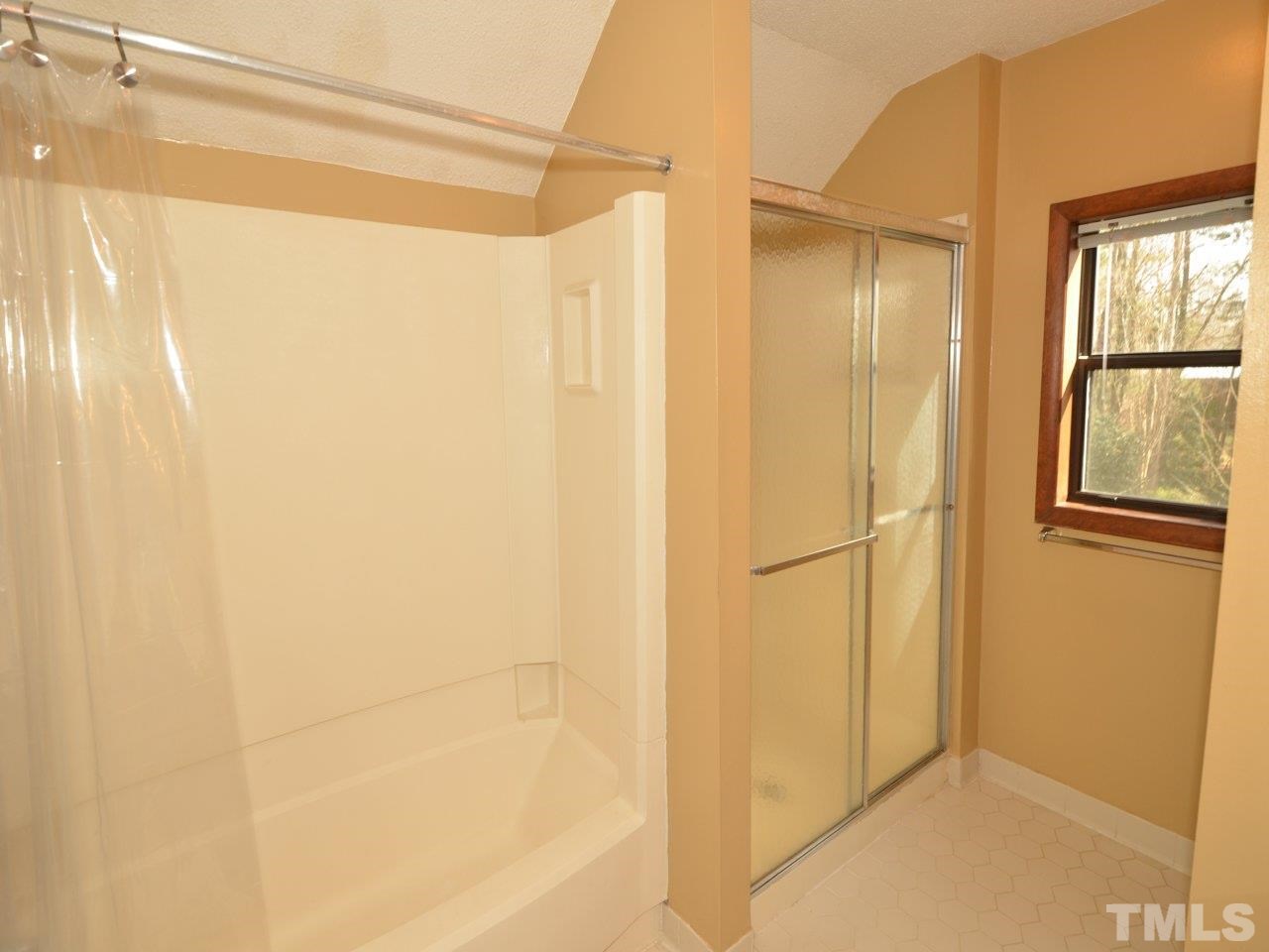 2812 Old Orchard Road Raleigh, NC 27607 - Photo 13 of 25 a bathroom with a glass shower door