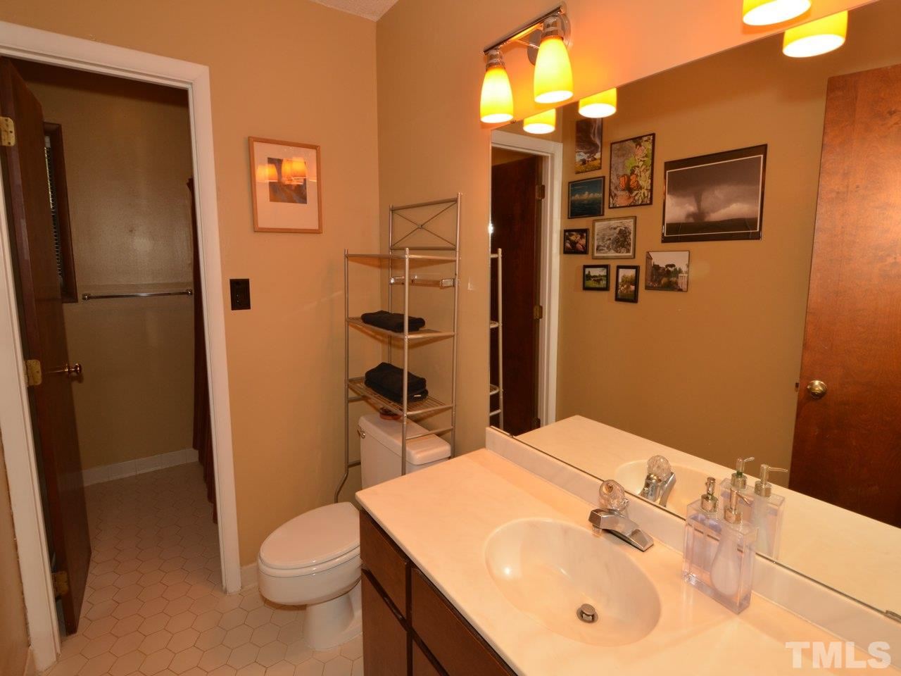 2812 Old Orchard Road Raleigh, NC 27607 - Photo 16 of 25 a bathroom with a sink a toilet and shower
