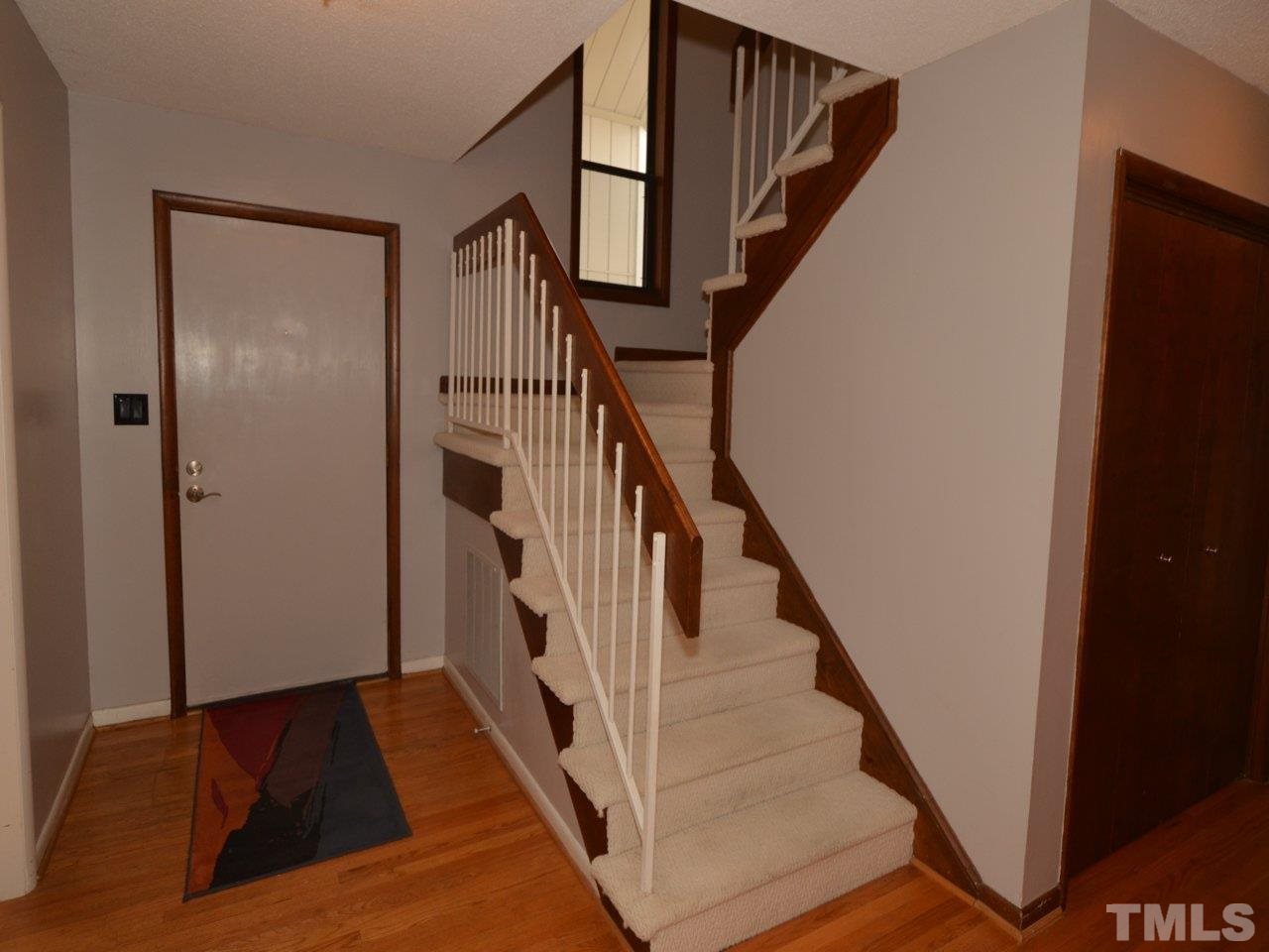 2812 Old Orchard Road Raleigh, NC 27607 - Photo 19 of 25 a view of a hallway with wooden floor and stairs