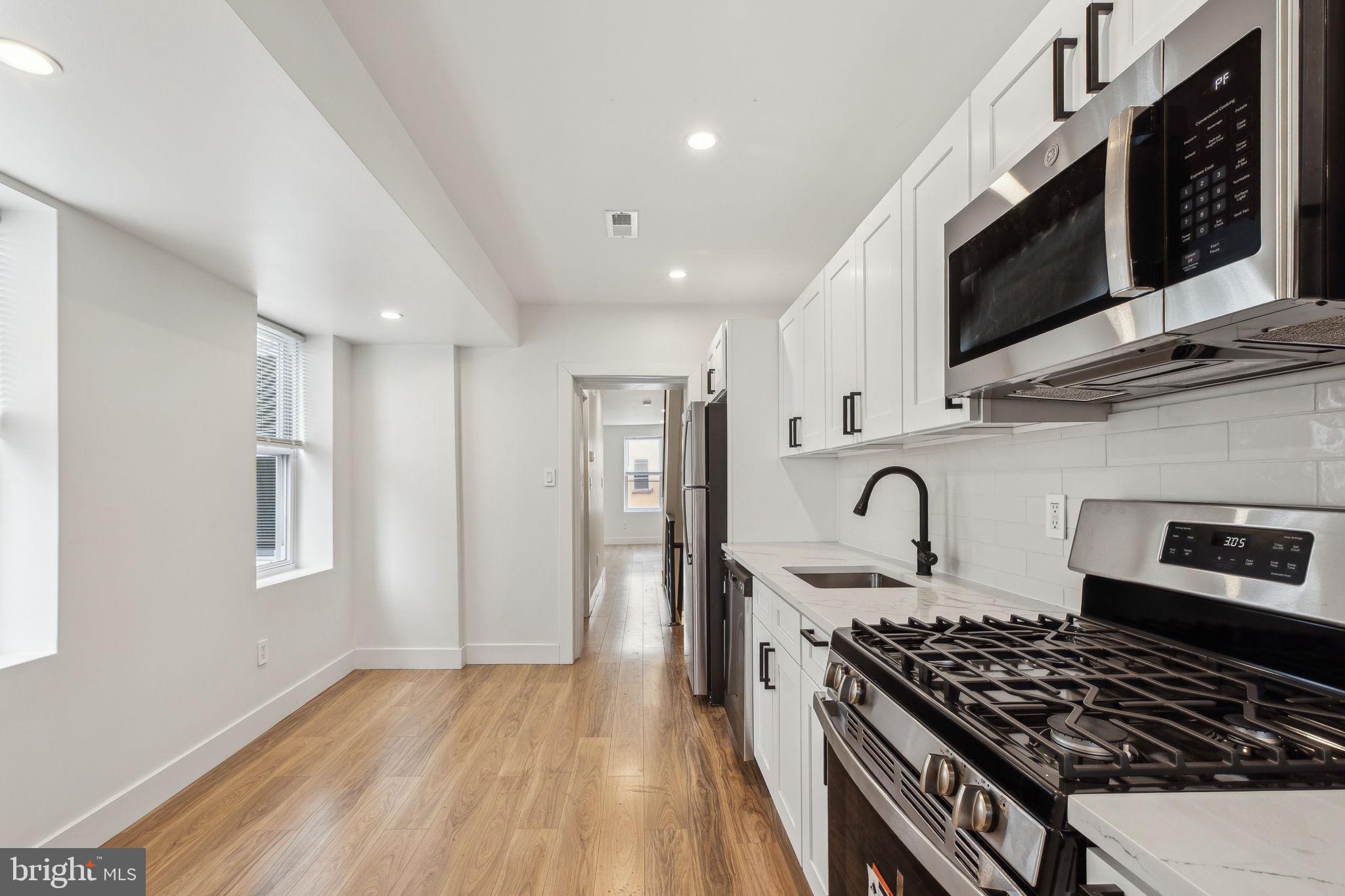 2014 North 3rd Street, Unit B Philadelphia, PA 19122 - Photo 1 of 19 a kitchen with stainless steel appliances granite countertop a stove and a sink