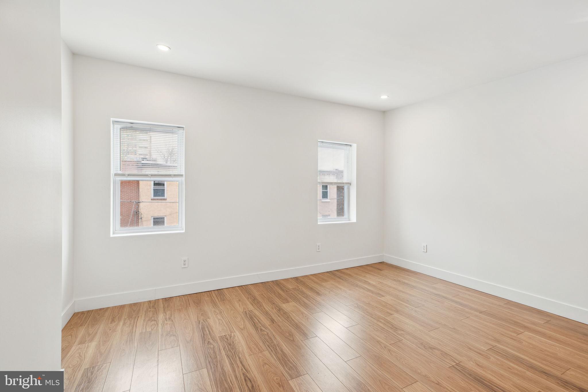 2014 North 3rd Street, Unit B Philadelphia, PA 19122 - Photo 16 of 19 an empty room with wooden floor and windows