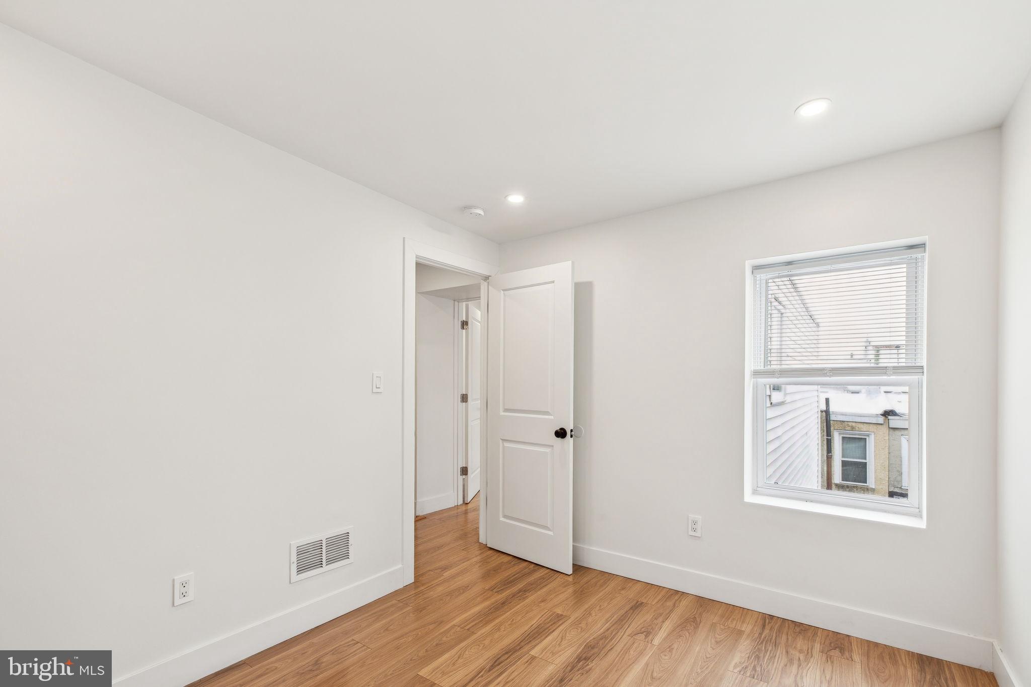 2014 North 3rd Street, Unit B Philadelphia, PA 19122 - Photo 18 of 19 a view of an empty room with wooden floor and a window