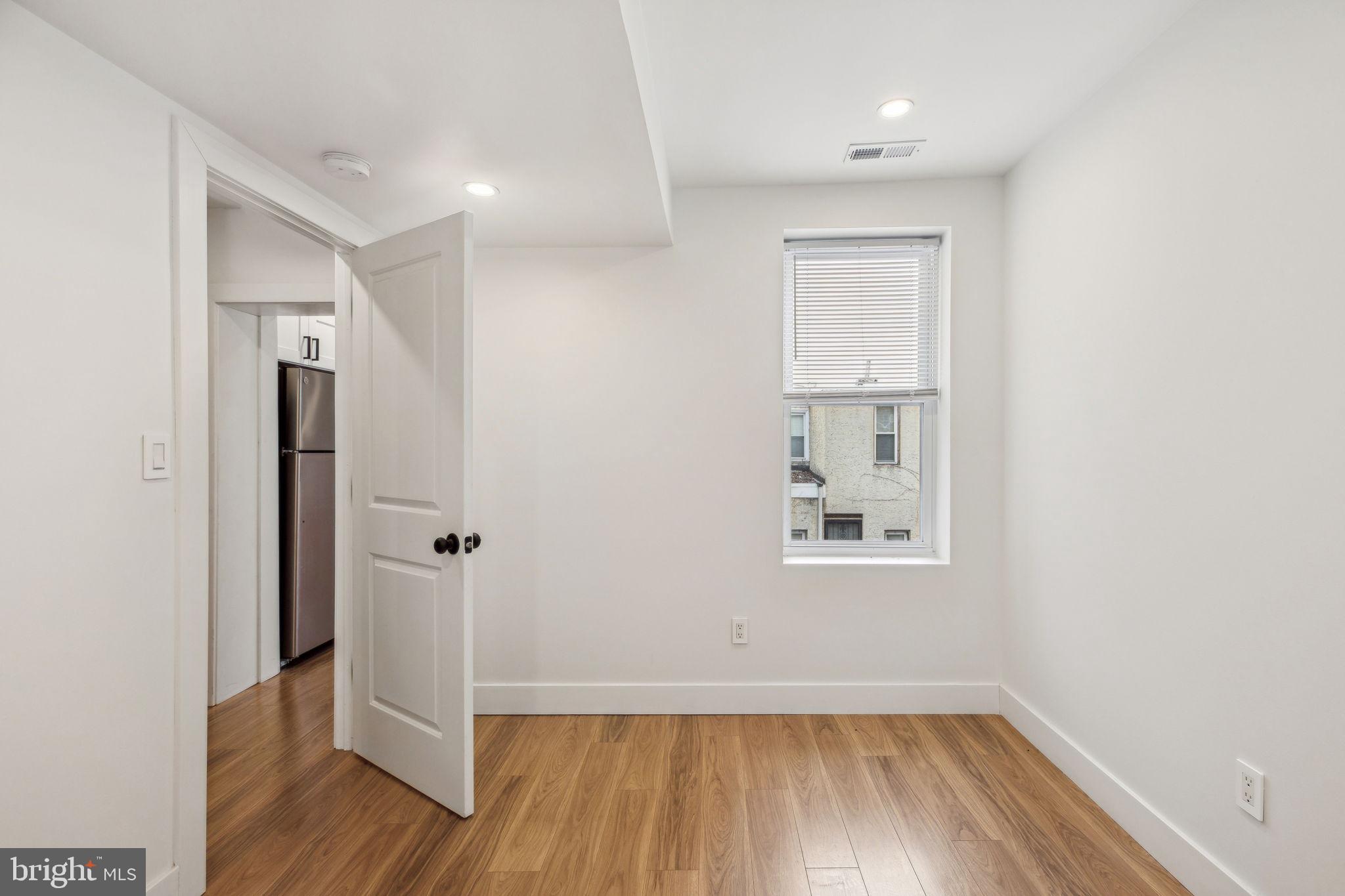 2014 North 3rd Street, Unit B Philadelphia, PA 19122 - Photo 7 of 19 an empty room with wooden floor and a window