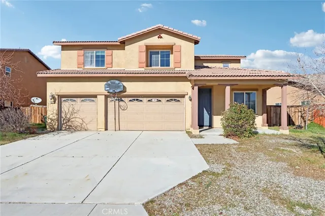 a view of a house with a yard and garage