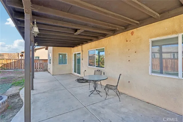 a view of patio with table and chairs and potted plants