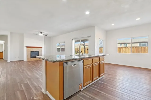 a kitchen with granite countertop a stove and cabinets