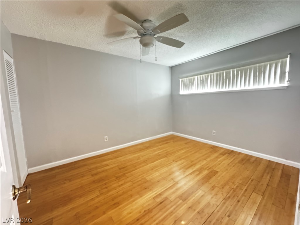 350 East Desert Inn Road, Unit C103 Las Vegas, NV 89109 - Photo 6 of 23 Hardwood floors and a ceiling fan create a comfortable atmosphere in this inviting space.
